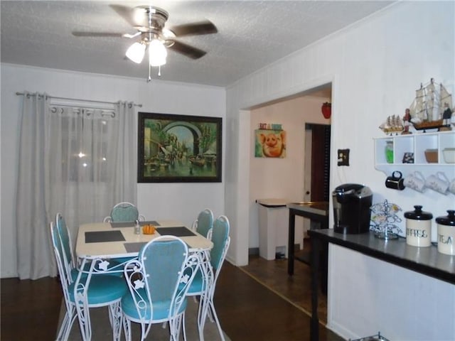 dining area with ceiling fan, a textured ceiling, and dark hardwood / wood-style flooring