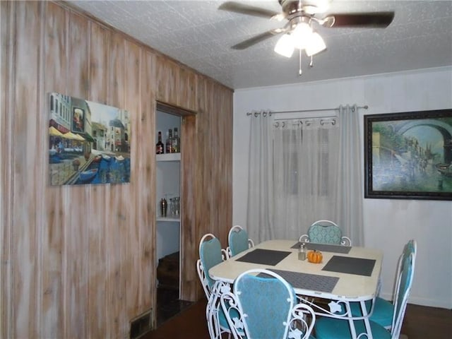 dining room with ceiling fan and dark hardwood / wood-style flooring