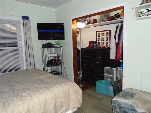 bedroom featuring ornamental molding and a closet