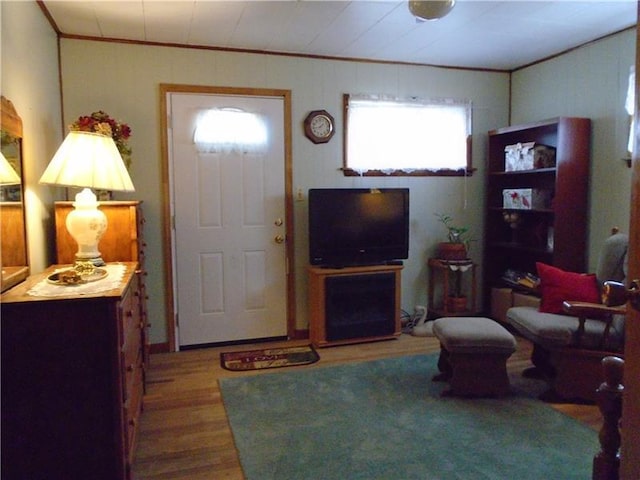 living room with crown molding and hardwood / wood-style flooring