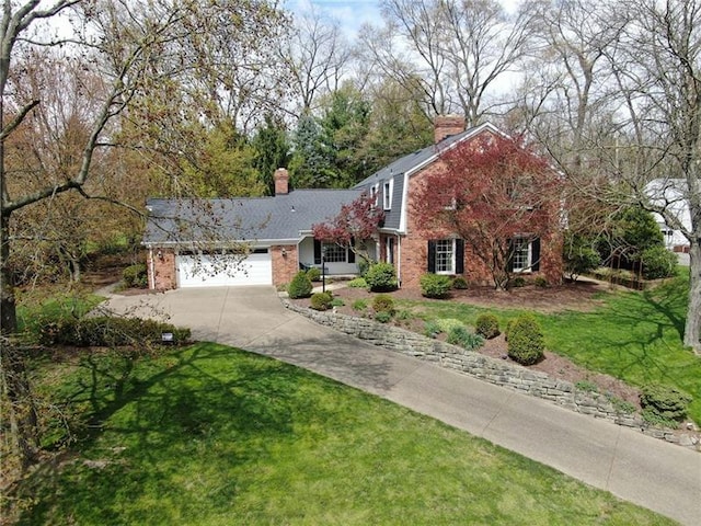 view of property featuring a front lawn and a garage