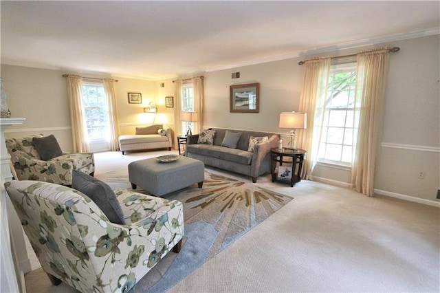 living room featuring plenty of natural light, ornamental molding, and light carpet