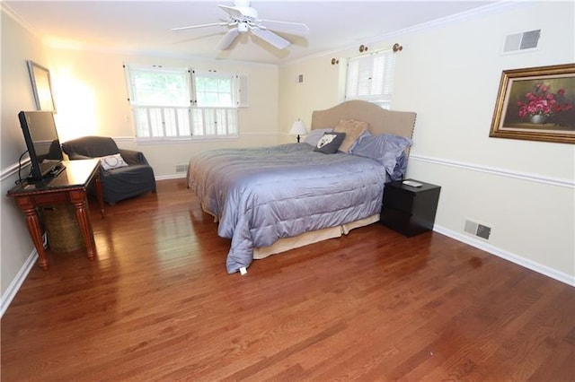 bedroom featuring ceiling fan, dark hardwood / wood-style floors, and crown molding