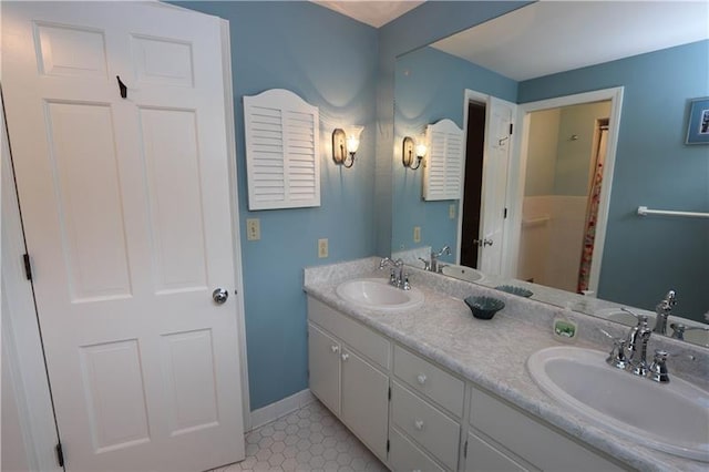 bathroom featuring dual sinks, tile floors, and vanity with extensive cabinet space