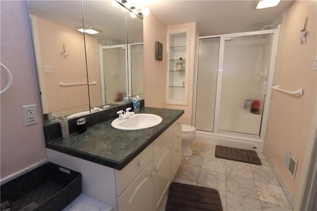 bathroom featuring tile floors, toilet, an enclosed shower, and vanity with extensive cabinet space