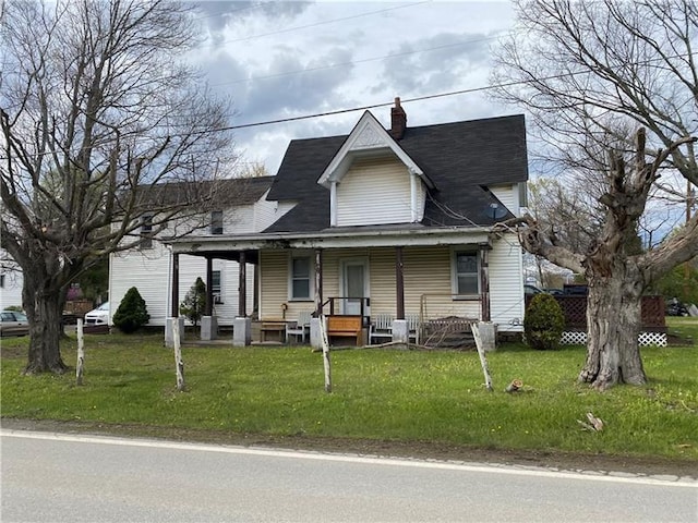 view of front of house with a porch and a front yard