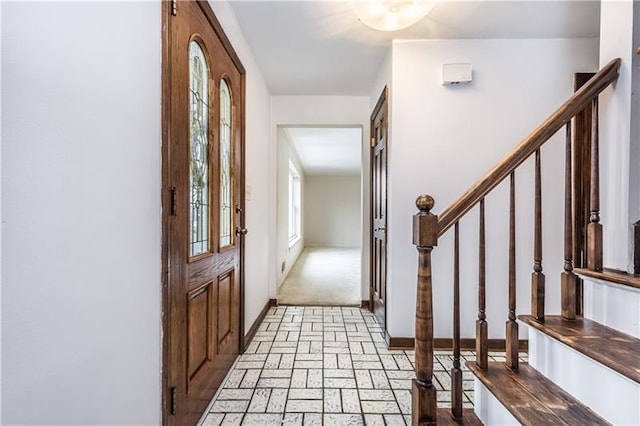 entryway with light colored carpet