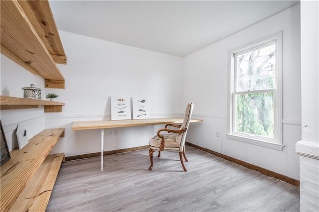 office featuring built in desk and light wood-type flooring