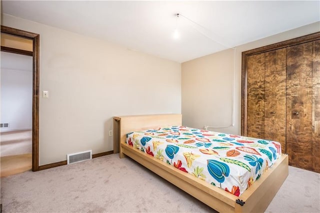 bedroom with a closet and light carpet