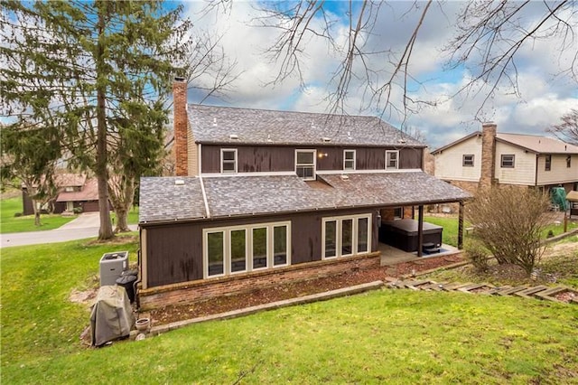 rear view of property with a lawn and french doors