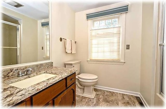 bathroom featuring tile floors, toilet, and vanity