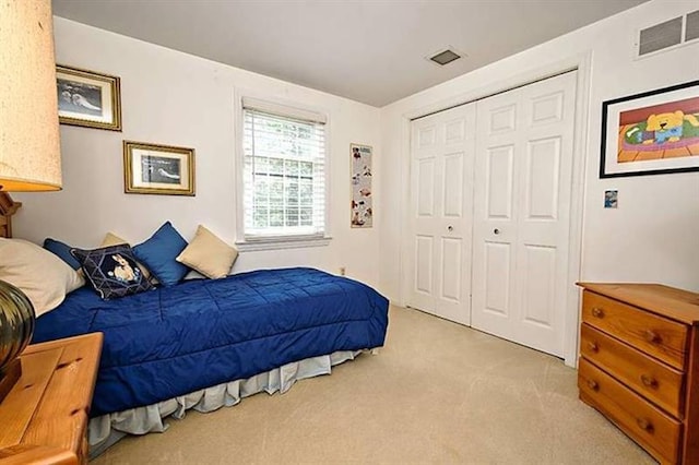 carpeted bedroom with a closet