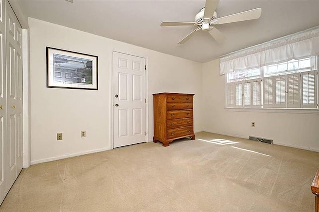 interior space with ceiling fan