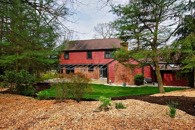 rear view of house with a yard