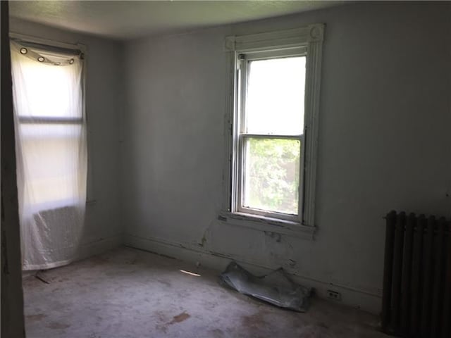 unfurnished room featuring radiator