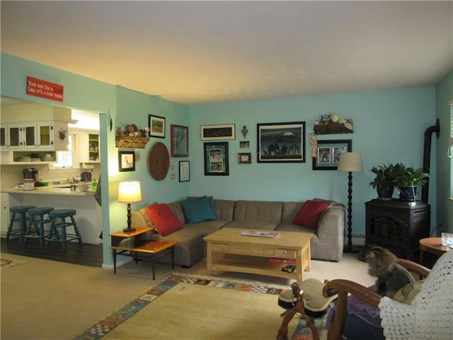 living room featuring a wood stove and hardwood / wood-style floors