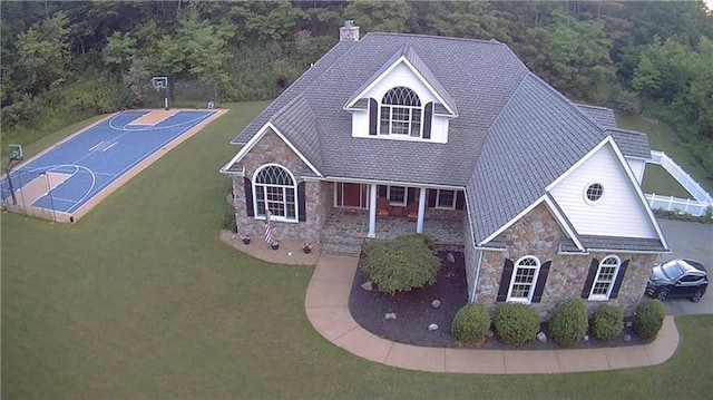 view of front of house featuring basketball court and a front lawn