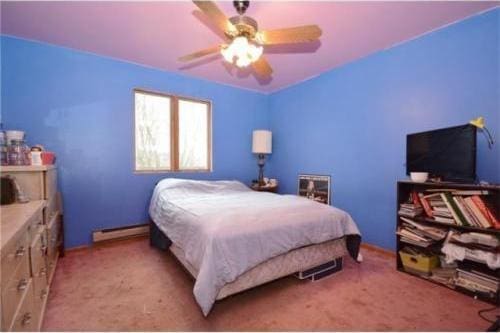 bedroom featuring a baseboard radiator, light colored carpet, and ceiling fan