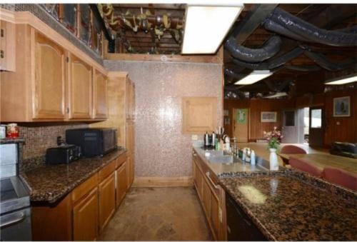 kitchen with dark stone counters and sink