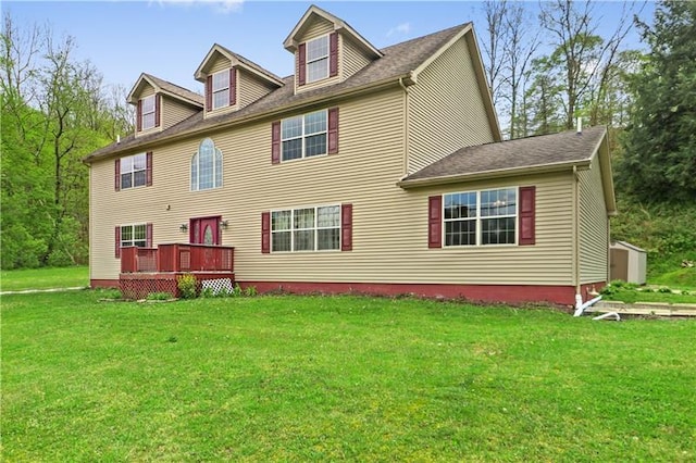 view of front of house with a front yard and a deck