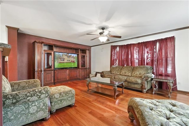 living room with ceiling fan, hardwood / wood-style flooring, and crown molding