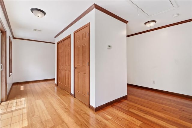 corridor featuring ornamental molding and light hardwood / wood-style floors