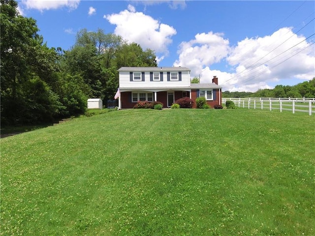 back of property featuring a lawn