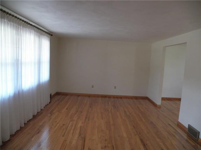 spare room featuring hardwood / wood-style floors