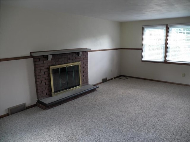 unfurnished living room featuring carpet flooring and a fireplace