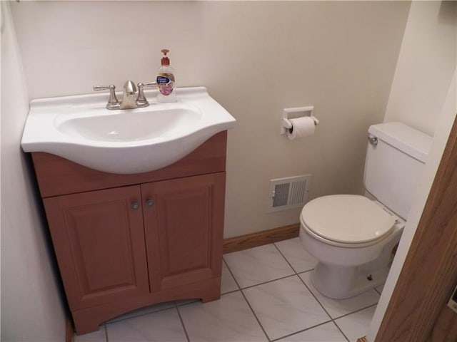 bathroom featuring vanity, tile flooring, and toilet