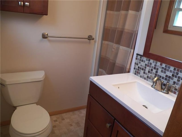 bathroom with tasteful backsplash, toilet, vanity, and tile flooring