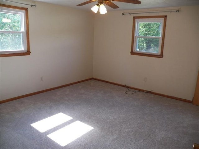 unfurnished room with carpet flooring, plenty of natural light, and ceiling fan