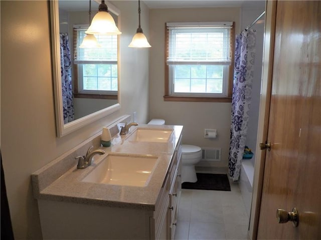 full bathroom featuring shower / bath combination with curtain, toilet, a wealth of natural light, and tile flooring