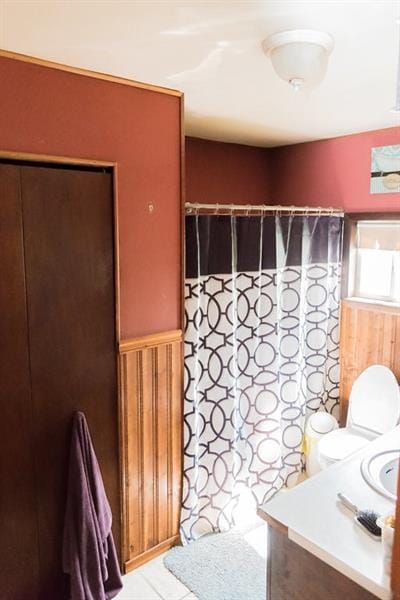 bathroom with tile floors, toilet, and vanity