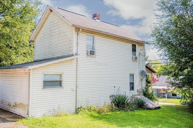 view of property exterior with a yard