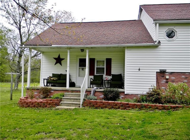 view of front of property featuring covered porch and a front yard