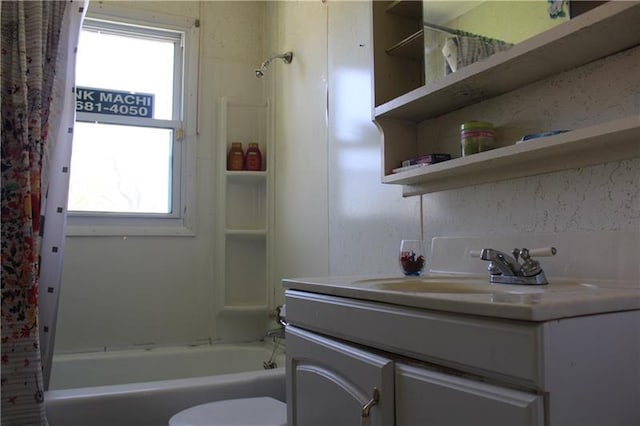 full bathroom with toilet, shower / bathtub combination with curtain, and vanity with extensive cabinet space