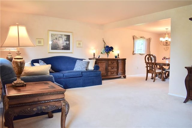 carpeted living room with a notable chandelier