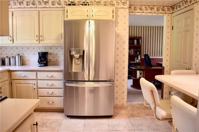 kitchen with light tile floors and stainless steel fridge with ice dispenser