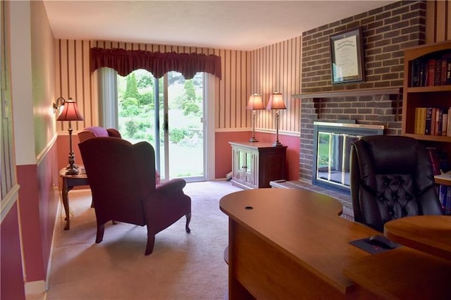 office area with light carpet, a fireplace, brick wall, and a wealth of natural light