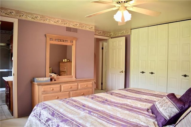 tiled bedroom with a closet and ceiling fan