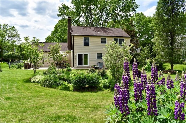 rear view of house with a yard