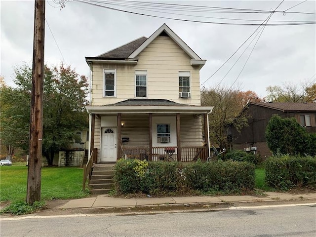 view of front of house featuring covered porch and a front lawn