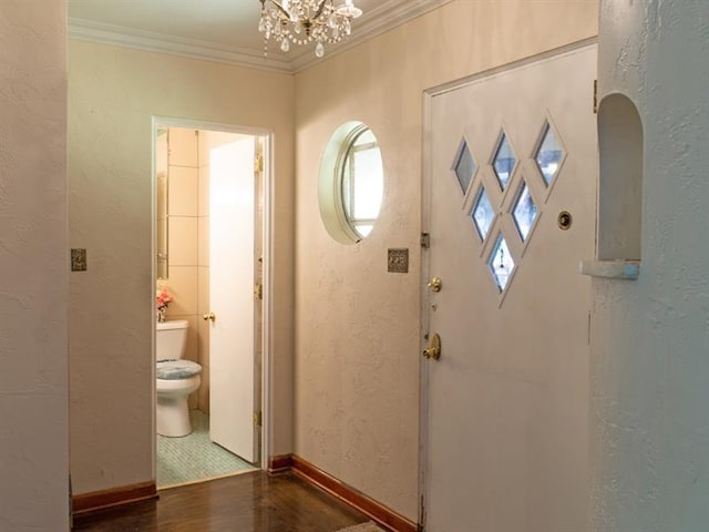 corridor featuring a chandelier, tile floors, and crown molding