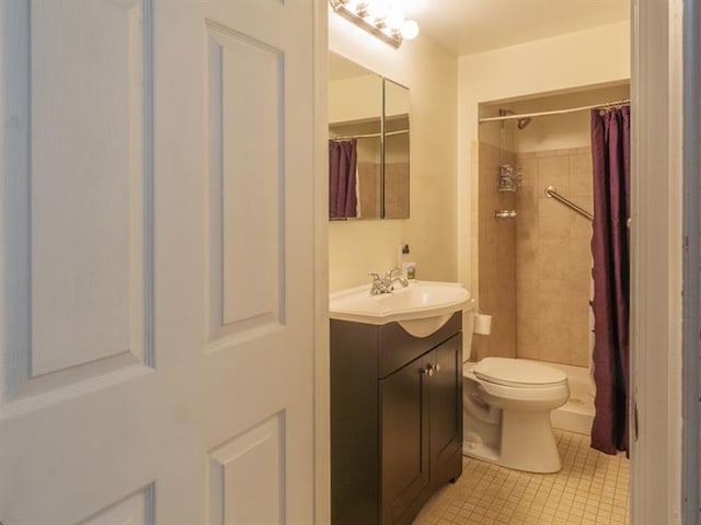 bathroom with vanity, curtained shower, tile floors, and toilet