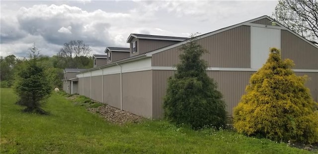 view of property exterior with a lawn