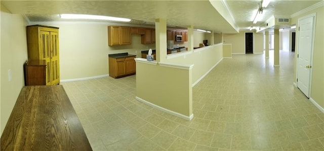 kitchen with crown molding and light tile flooring