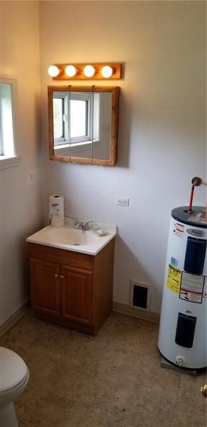 bathroom with vanity, tile flooring, electric water heater, and toilet