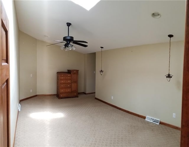 unfurnished living room featuring light colored carpet and ceiling fan