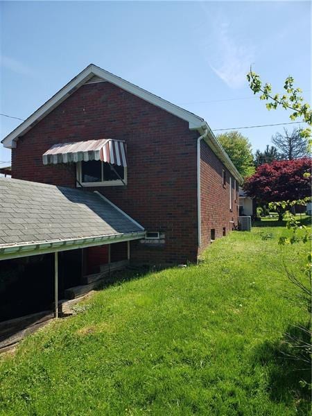 view of property exterior featuring a lawn and central air condition unit